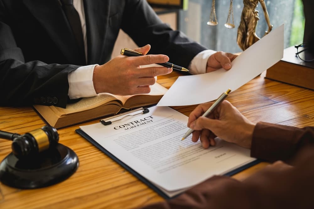 Attorneys or lawyers reading the statute of limitations during a consultation between male lawyers and business clients, discussing tax and legal services.