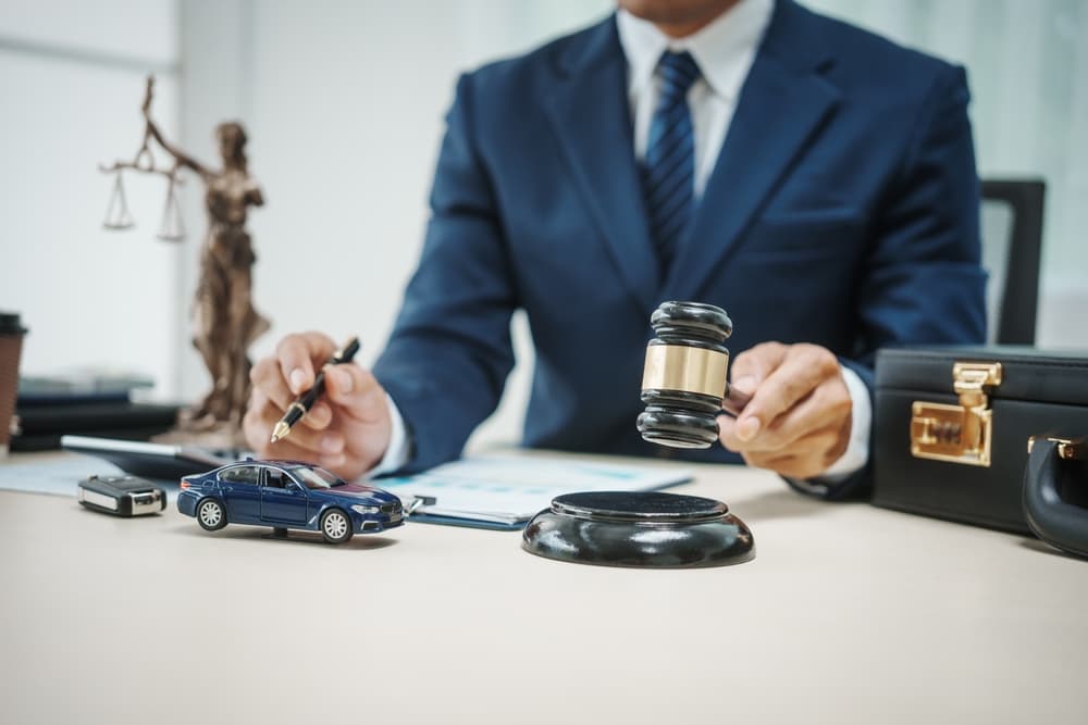 A gavel and car symbolizing auto law, justice, and legal matters related to vehicle accidents.