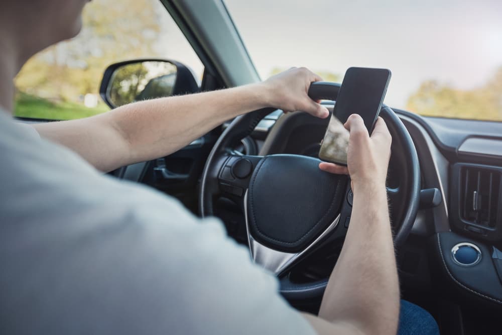 A man is using phone while driving