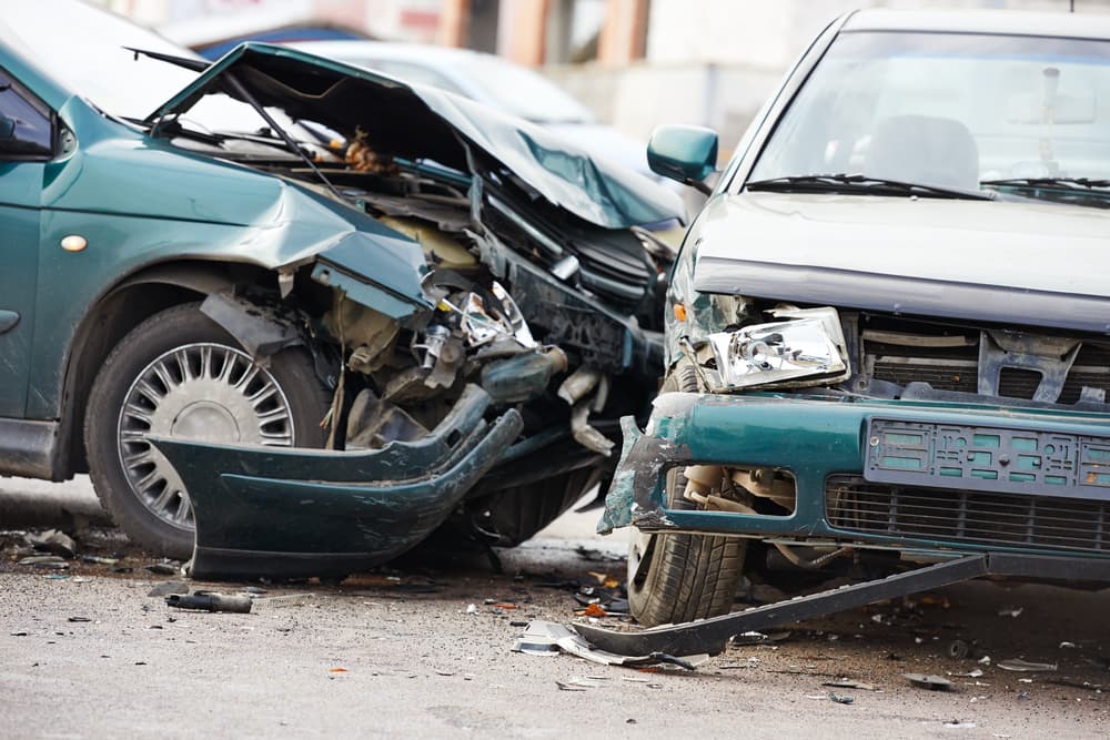 Car crash accident on street, damaged automobiles after collision in city