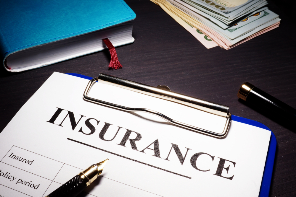 Insurance policy form and pen on a desk.