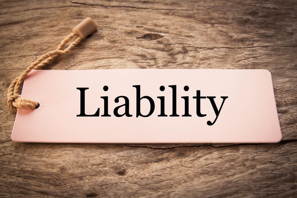 Liability note text on wood