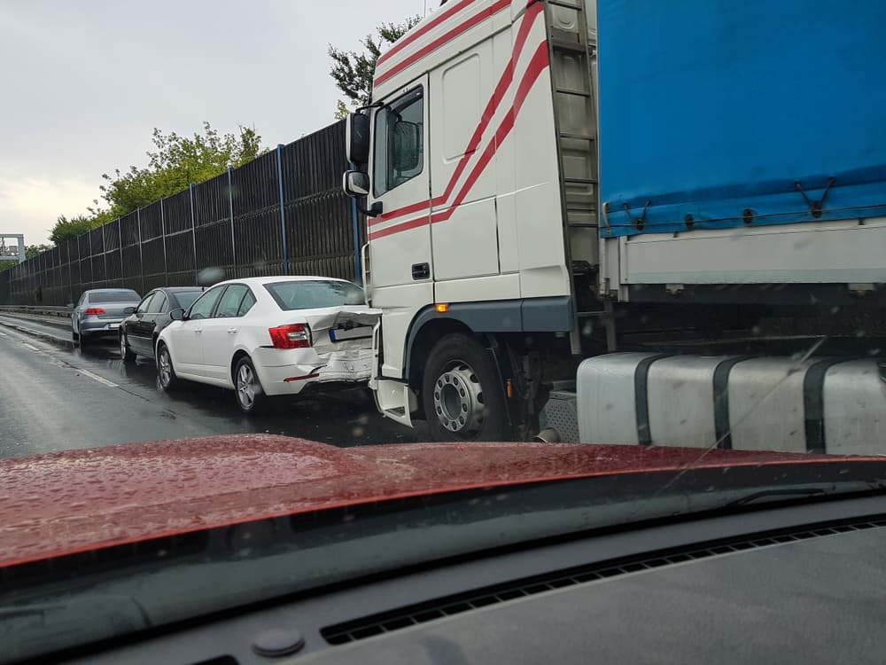 Truck rear ended passenger car in the rain